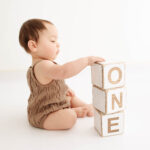 one year old baby playing at his photoshoot