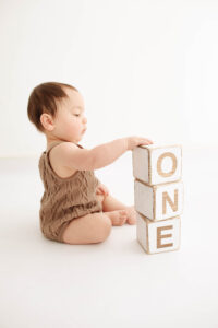 one year old baby playing at his photoshoot