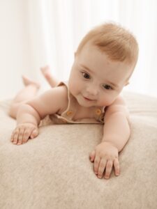 happy playful baby at beautiful photoshoot