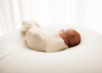 newborn baby at photoshoot wrapped up in a baby blanket