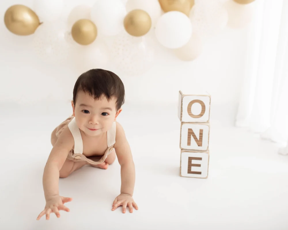 baby at one-year photoshoot with balloons in Wimbeldon