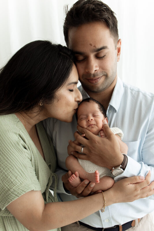 parents holding newborn baby at photoshoot in Kingston Upon Thames